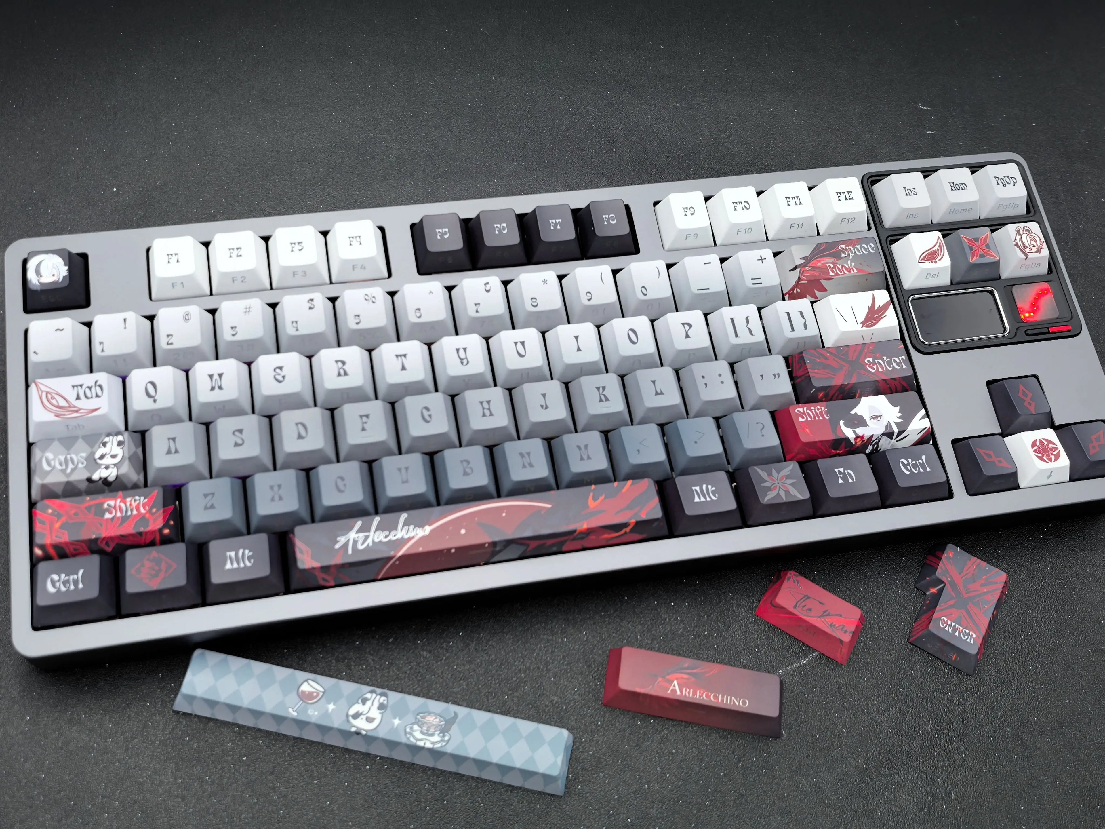 Close-up of Arlecchino Genshin Impact keycaps on a mechanical keyboard