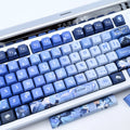 A close-up of a mechanical keyboard with Furina keycaps on a white surface.