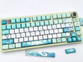 Close-up of the left side of the Venti Genshin Impact keycap set on a mechanical keyboard, showing keys up to the I, K, M row